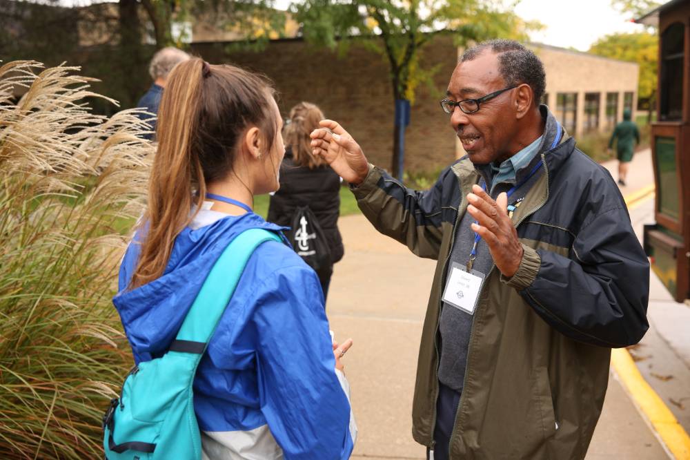 An alumnus talking to a student on the campus tour.